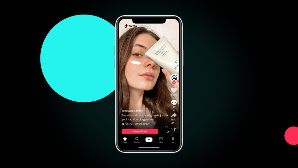 A TikTok ad mockup showing a woman applying skincare cream and holding a product tube, set against a dark background with bold turquoise and pink circles. Includes keyword: tiktok ads that sell shopify.